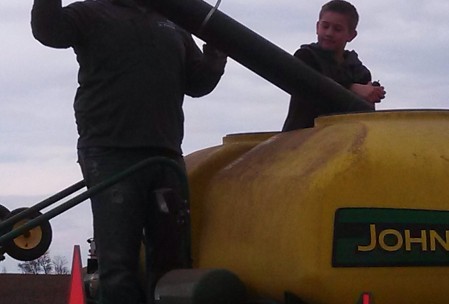 George filling the yellow bin with seed.